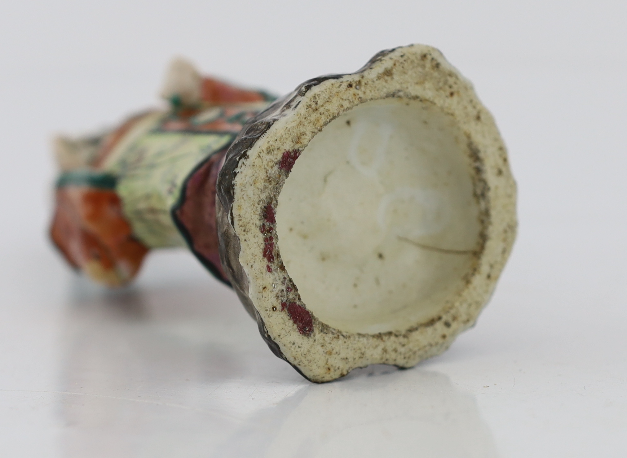 A Chinese enamelled porcelain figure of a court official, Jiaqing period (1796-1820), loss to right index finger